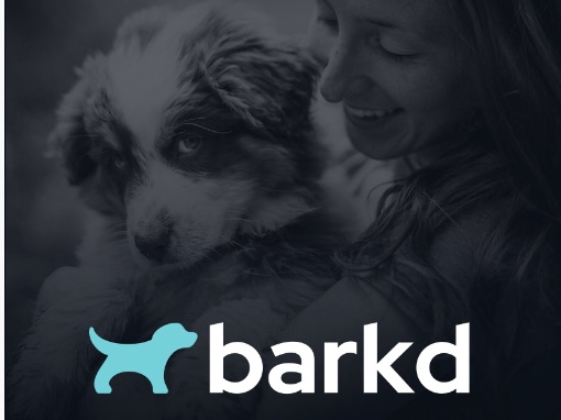 Black-and-white photograph of a person holding a puppy.